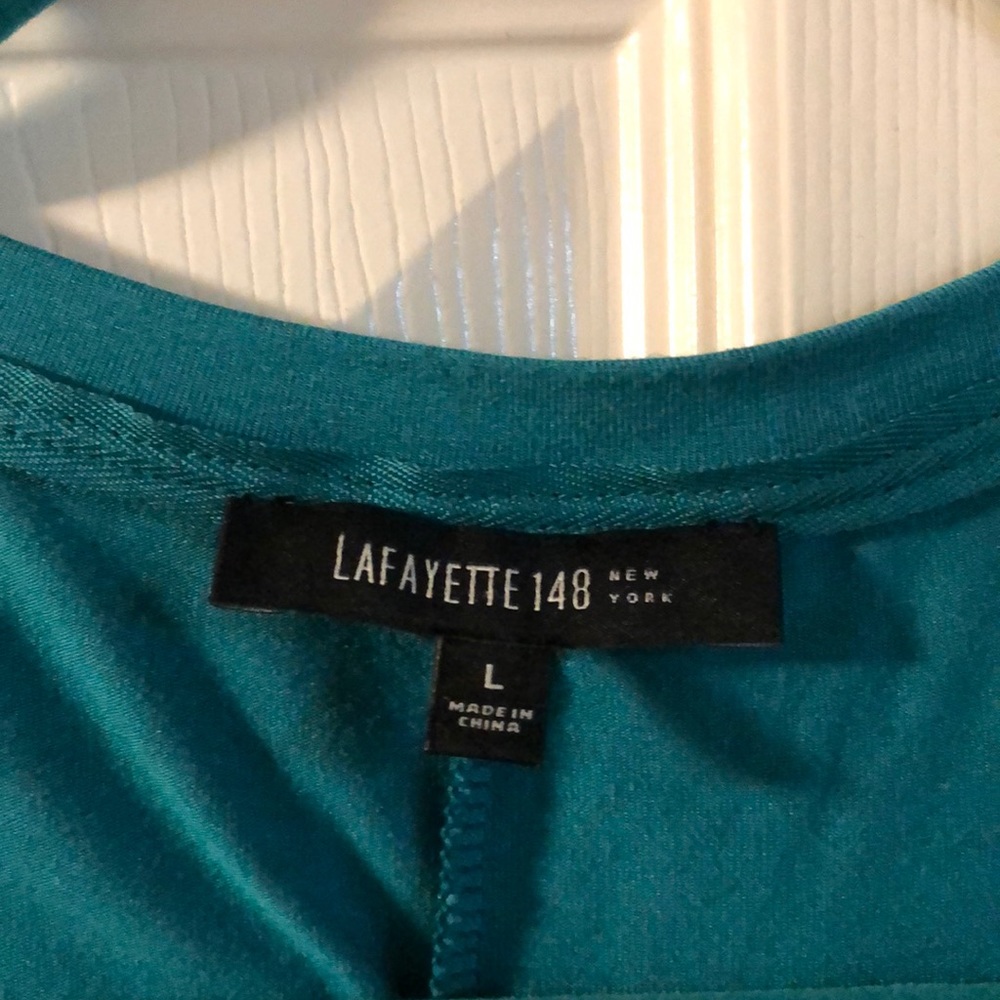 This is a Lafayette 148 ombré green tunic.